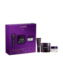 Caudalie Premier Cru Set - Premier Cru kreme 50 ml + 2 poklona Premier Cru bogata krema 15 ml i Premier Cru krema za područje oko očiju 5 ml. Ljubičasta kutija i proizvodi sa strane nje na bijeloj pozadini.