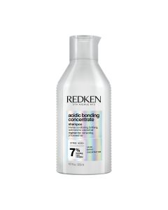 Redken NYC Acidic Bonding Concentrate Šampon 300 ml - Sadrži limunsku kiselinu, pomaže u zaštiti slabih veza i pomaže poboljšati snagu i otpornost kose nakon izbjeljivanja ili bojanja. Srebna boca sa etiketom duginih boja na bijeloj pozadini.