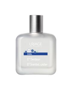 Uriage Bebe Prvi parfem 50 ml - bez alkohola, prvi miris s kompleksom [Uriage termalna voda + organski runolist] poštuje nježnu kožu male djece. Bijelo srebrna bočica parfema na bijeloj pozadini.